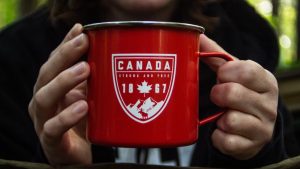 A red mug with a symbol that says Canada